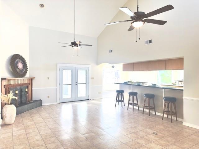 4231 San Trovaso St, New Orleans, LA 70129 - living area with ceiling fan, high vaulted ceiling, and french doors