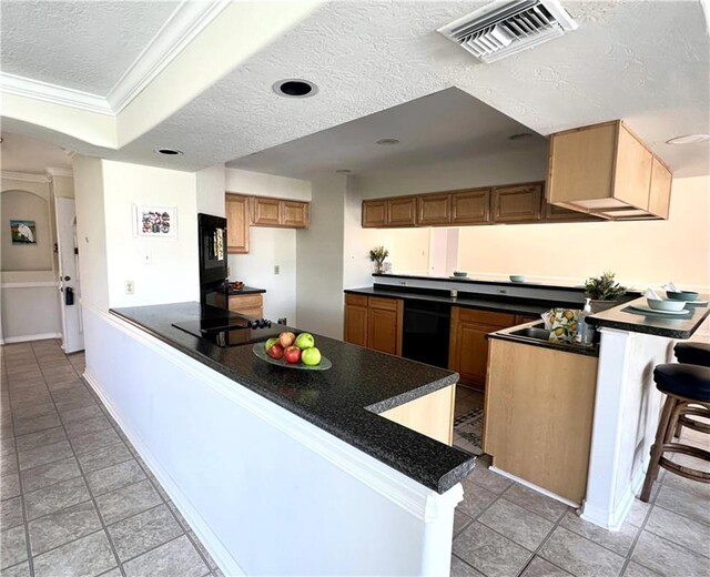 4231 San Trovaso St, New Orleans, LA 70129 - kitchen with a peninsula, black appliances, a textured ceiling, crown molding, and dark countertops
