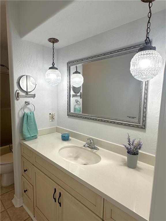 4231 San Trovaso St, New Orleans, LA 70129 - bathroom with vanity, tile patterned flooring, a shower, and a textured wall