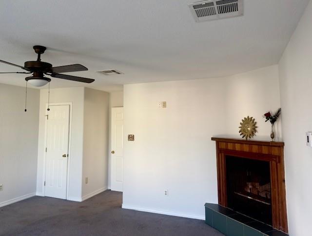 4231 San Trovaso St, New Orleans, LA 70129 - unfurnished living room with ceiling fan, dark carpet, and a fireplace