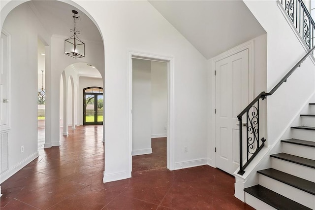 155 Sauve Rd, River Ridge, LA 70123 - entrance foyer featuring arched walkways, stairs, baseboards, and vaulted ceiling