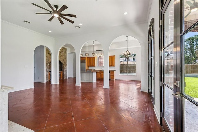 155 Sauve Rd, River Ridge, LA 70123 - unfurnished living room with arched walkways, healthy amount of natural light, ceiling fan, crown molding, and recessed lighting