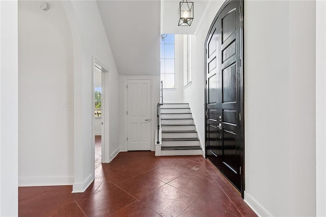 155 Sauve Rd, River Ridge, LA 70123 - foyer entrance featuring stairway, baseboards, dark tile patterned floors, and vaulted ceiling