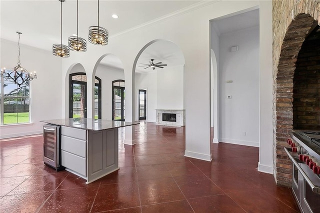 155 Sauve Rd, River Ridge, LA 70123 - kitchen with wine cooler, healthy amount of natural light, arched walkways, a chandelier, and ornamental molding