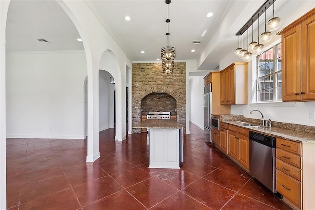155 Sauve Rd, River Ridge, LA 70123 - kitchen with appliances with stainless steel finishes, a sink, light stone counters, a center island, and ornamental molding