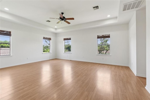 155 Sauve Rd, River Ridge, LA 70123 - spare room featuring a tray ceiling, light wood-type flooring, a ceiling fan, baseboards, and recessed lighting