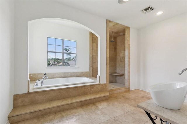 155 Sauve Rd, River Ridge, LA 70123 - bathroom featuring a bath, a tile shower, tile patterned flooring, and recessed lighting