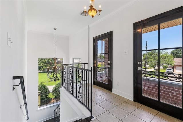 155 Sauve Rd, River Ridge, LA 70123 - entryway featuring a chandelier, tile patterned floors, baseboards, ornamental molding, and plenty of natural light