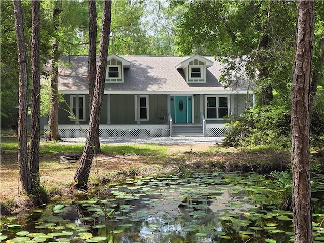 59478 S Tranquility Rd, Lacombe, LA 70445 - cape cod house featuring covered porch and roof with shingles
