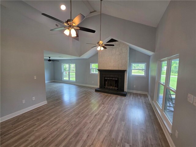 59478 S Tranquility Rd, Lacombe, LA 70445 - unfurnished living room featuring high vaulted ceiling, plenty of natural light, baseboards, wood finished floors, and beamed ceiling