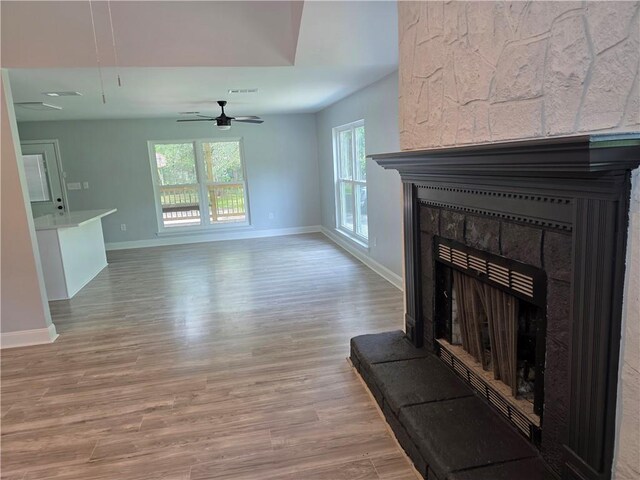 59478 S Tranquility Rd, Lacombe, LA 70445 - unfurnished living room with light wood-style floors, baseboards, and a fireplace