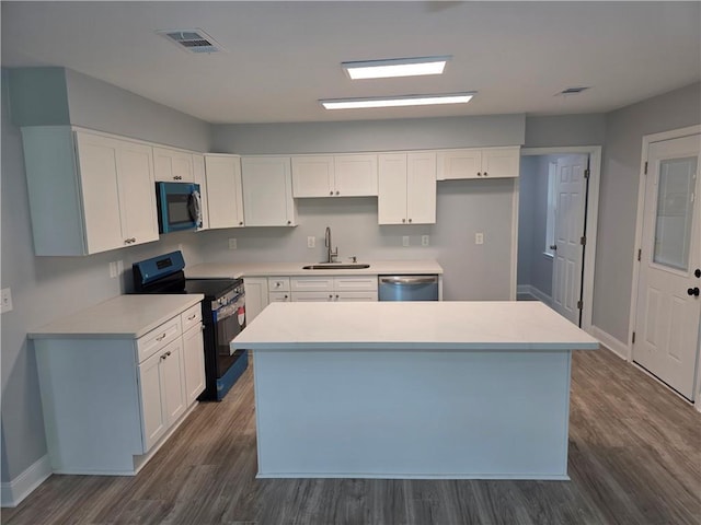 59478 S Tranquility Rd, Lacombe, LA 70445 - kitchen with stainless steel appliances, a sink, dark wood-style flooring, baseboards, and white cabinetry