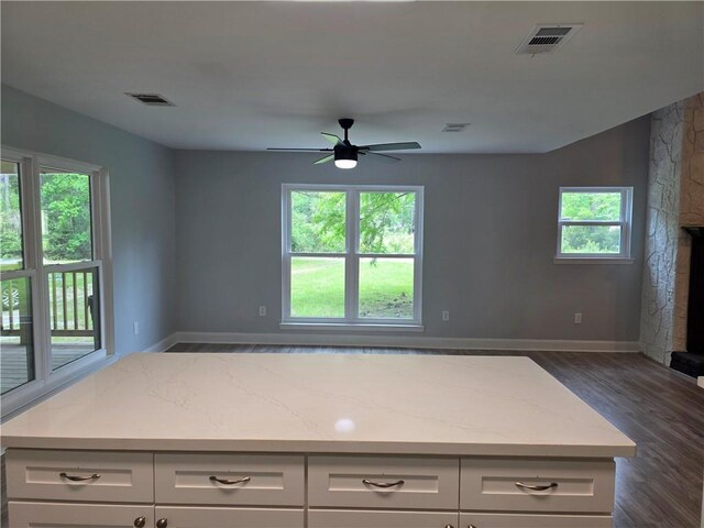 59478 S Tranquility Rd, Lacombe, LA 70445 - kitchen with dark wood-type flooring, a ceiling fan, open floor plan, white cabinetry, and baseboards