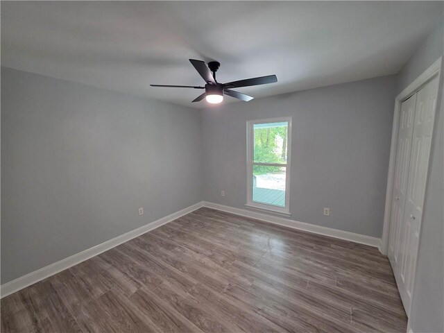 59478 S Tranquility Rd, Lacombe, LA 70445 - unfurnished bedroom featuring a closet, dark wood-style floors, baseboards, and a ceiling fan