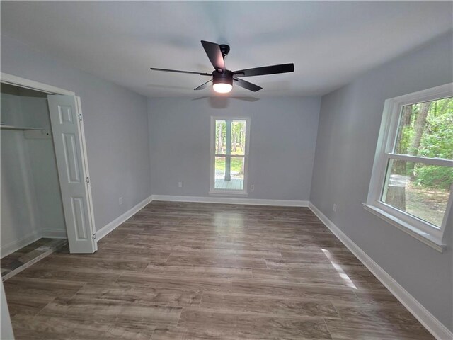 59478 S Tranquility Rd, Lacombe, LA 70445 - unfurnished bedroom with wood finished floors, a closet, baseboards, and a ceiling fan