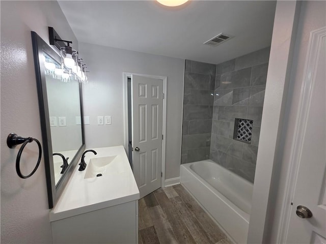 59478 S Tranquility Rd, Lacombe, LA 70445 - full bathroom with wood finished floors, vanity, washtub / shower combination, and baseboards