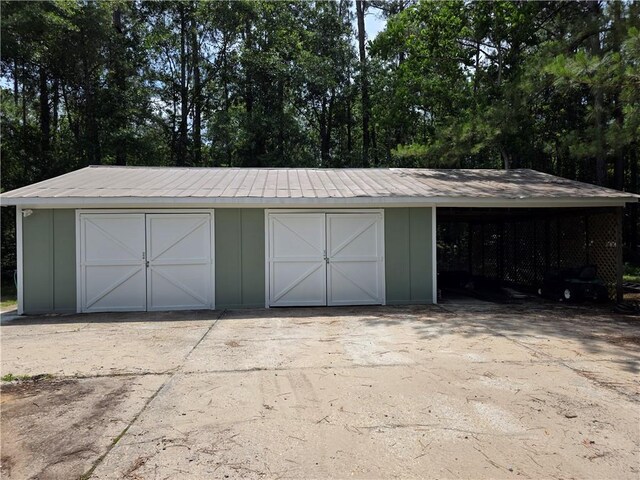 59478 S Tranquility Rd, Lacombe, LA 70445 - garage with a detached garage and view of scattered trees