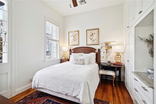 927 Dauphine St, New Orleans, LA 70116 - bedroom with dark wood-type flooring, baseboards, and a ceiling fan