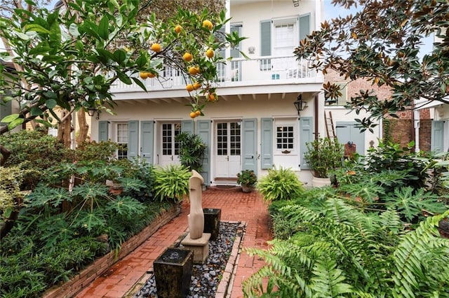 927 Dauphine St, New Orleans, LA 70116 - rear view of property with a balcony, french doors, and stucco siding