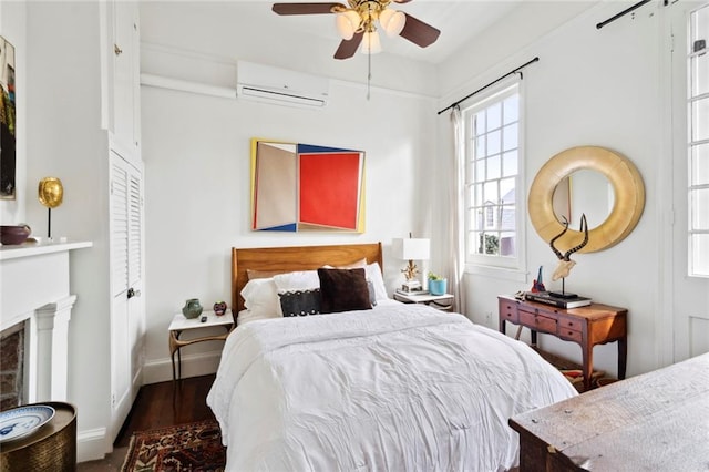 927 Dauphine St, New Orleans, LA 70116 - bedroom featuring a wall mounted air conditioner, wood finished floors, a fireplace, baseboards, and ceiling fan