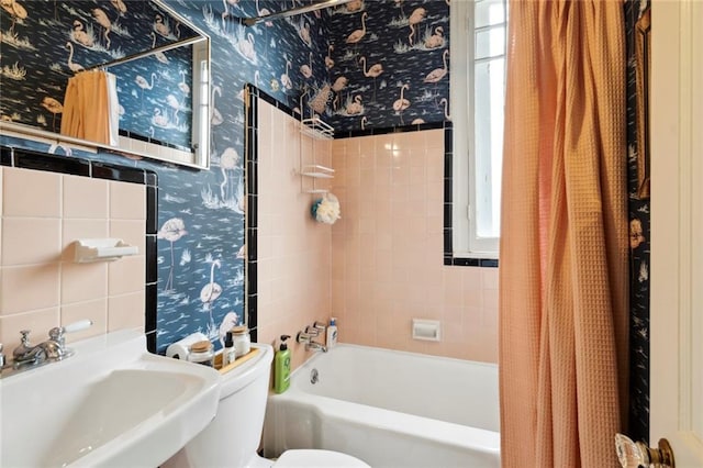 927 Dauphine St, New Orleans, LA 70116 - bathroom with wallpapered walls, toilet, a sink, and shower / tub combo with curtain