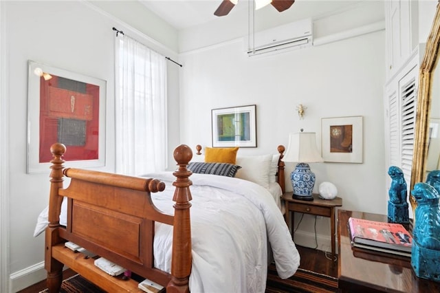 927 Dauphine St, New Orleans, LA 70116 - bedroom featuring an AC wall unit, baseboards, wood finished floors, and a ceiling fan