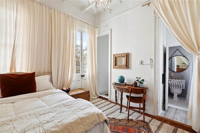 927 Dauphine St, New Orleans, LA 70116 - bedroom featuring wood finished floors and a chandelier