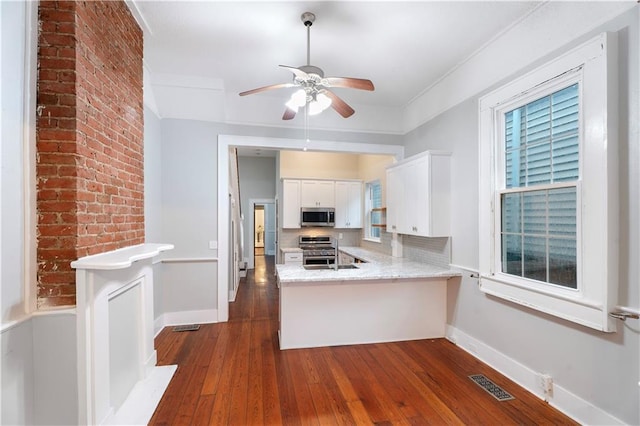 82729 Mazant St, New Orleans, LA 70117 - kitchen with stainless steel appliances, dark wood-style floors, white cabinets, a ceiling fan, and baseboards
