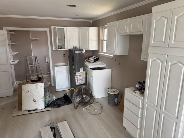 7916 Unity Dr, New Orleans, LA 70128 - kitchen with light wood finished floors, white cabinets, water heater, washer / dryer, and light countertops