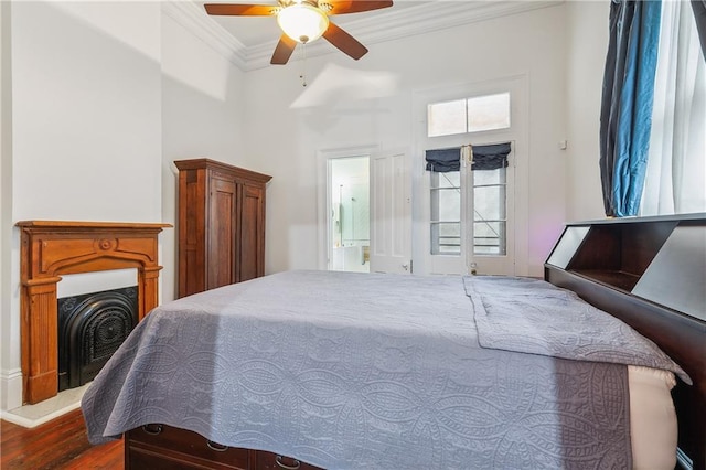 820 St Ann St Unit A, New Orleans, LA 70116 - bedroom with crown molding, a fireplace with raised hearth, wood finished floors, ensuite bath, and ceiling fan