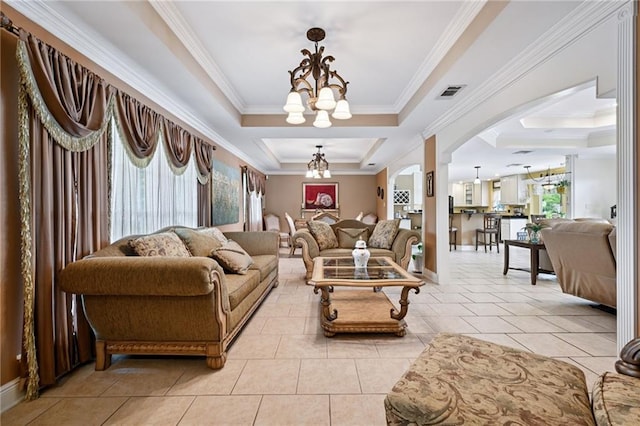 581 S Military Rd, Slidell, LA 70461 - living room featuring crown molding, a chandelier, a raised ceiling, arched walkways, and light tile patterned floors