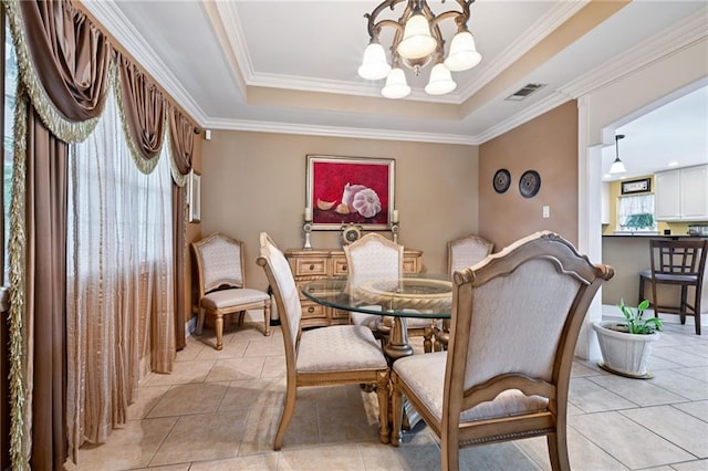 581 S Military Rd, Slidell, LA 70461 - dining room featuring a chandelier, light tile patterned flooring, crown molding, and a raised ceiling