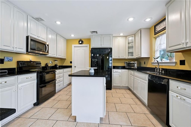 581 S Military Rd, Slidell, LA 70461 - kitchen with black appliances, a sink, dark countertops, a center island, and recessed lighting