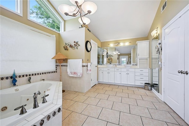 581 S Military Rd, Slidell, LA 70461 - full bath with lofted ceiling, a chandelier, vanity, a whirlpool tub, and tile patterned flooring