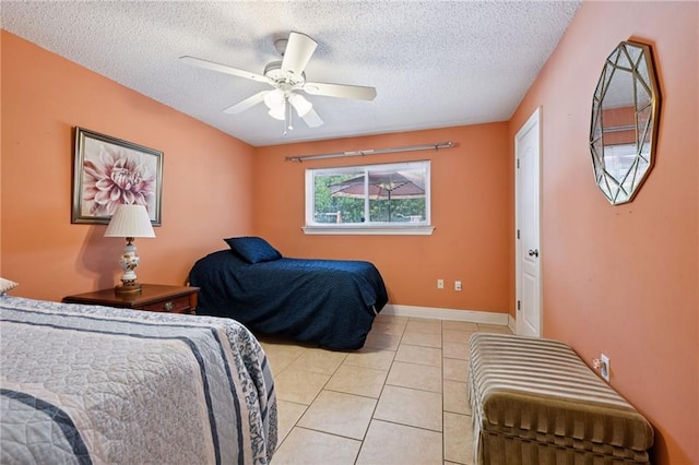 581 S Military Rd, Slidell, LA 70461 - bedroom featuring light tile patterned flooring, a textured ceiling, ceiling fan, and baseboards