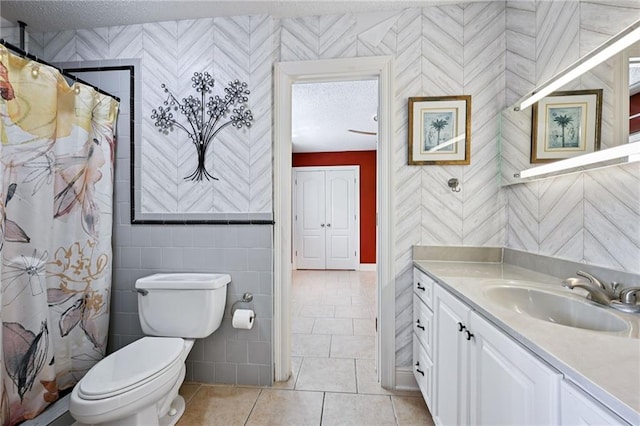 581 S Military Rd, Slidell, LA 70461 - bathroom with vanity, toilet, wallpapered walls, a textured ceiling, and tile patterned floors