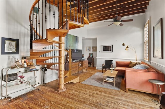 4716 Annunciation St Unit 3A, New Orleans, LA 70115 - living area with stairway, a towering ceiling, ceiling fan, and wood finished floors