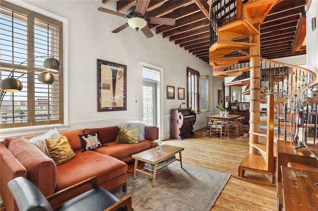 4716 Annunciation St Unit 3A, New Orleans, LA 70115 - living room with plenty of natural light, a ceiling fan, wood finished floors, beam ceiling, and a high ceiling