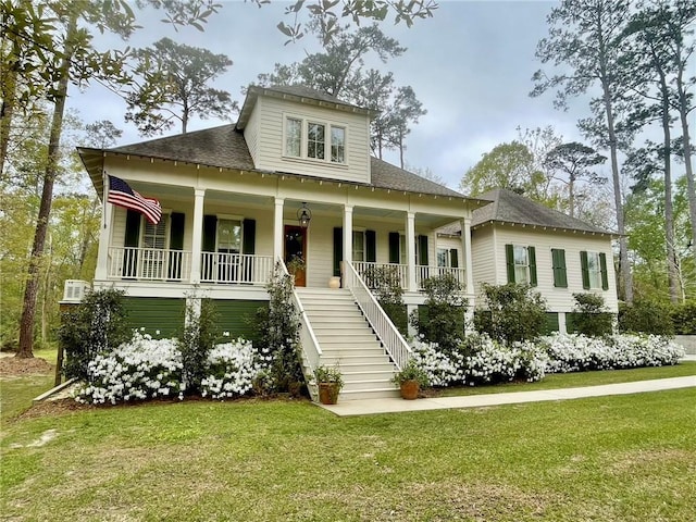 607 E 3rd Ave, Covington, LA 70433 - view of front of home with a porch, stairway, a front yard, and roof with shingles