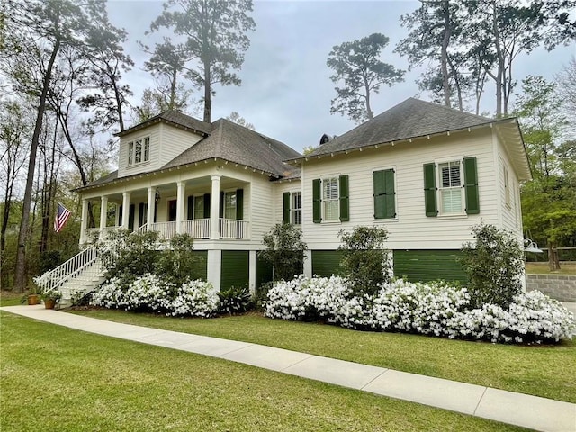 607 E 3rd Ave, Covington, LA 70433 - view of front of home with a porch, a front yard, roof with shingles, and stairs