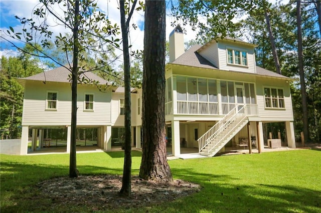 607 E 3rd Ave, Covington, LA 70433 - back of house featuring a chimney, a sunroom, stairway, and a shingled roof