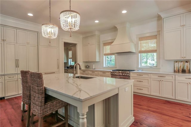 607 E 3rd Ave, Covington, LA 70433 - kitchen featuring a sink, custom range hood, a chandelier, high end stove, and light stone countertops