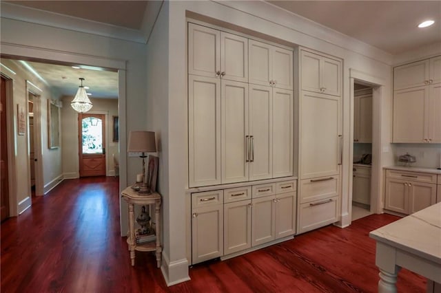 607 E 3rd Ave, Covington, LA 70433 - kitchen featuring dark wood-style floors, baseboards, a chandelier, light stone counters, and recessed lighting