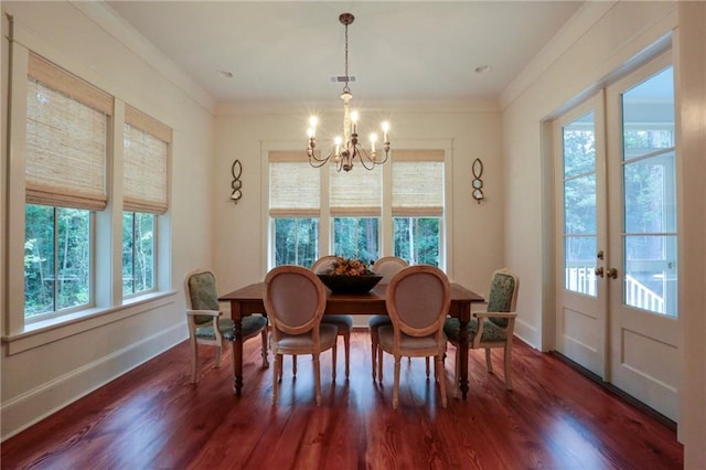 607 E 3rd Ave, Covington, LA 70433 - dining area with a chandelier, wood finished floors, french doors, baseboards, and ornamental molding