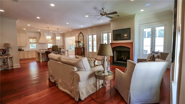 607 E 3rd Ave, Covington, LA 70433 - living room featuring healthy amount of natural light, dark wood-style floors, recessed lighting, a fireplace with flush hearth, and a ceiling fan