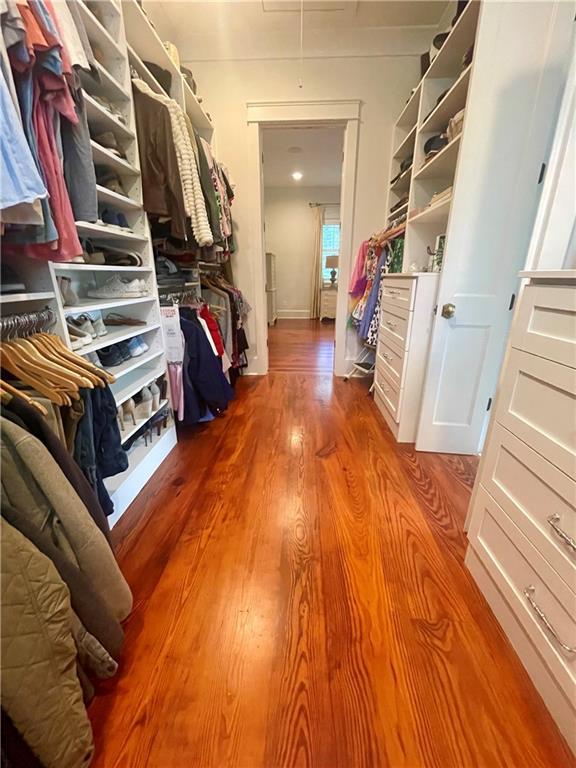 607 E 3rd Ave, Covington, LA 70433 - walk in closet with wood finished floors and attic access