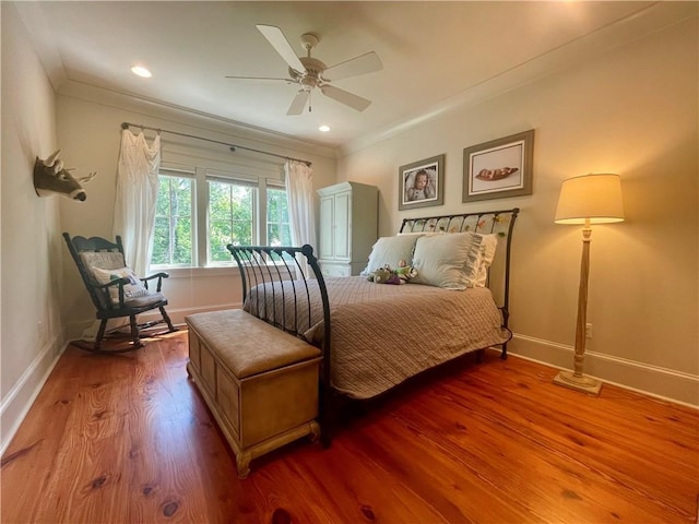 607 E 3rd Ave, Covington, LA 70433 - bedroom with crown molding, baseboards, wood finished floors, a ceiling fan, and recessed lighting