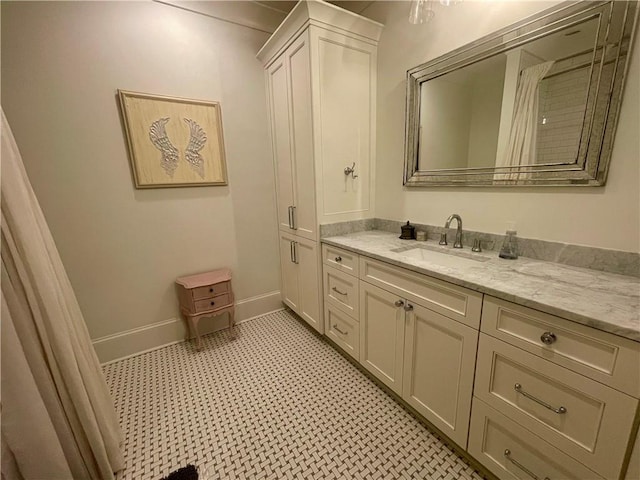 607 E 3rd Ave, Covington, LA 70433 - bathroom with vanity, tile patterned floors, and baseboards