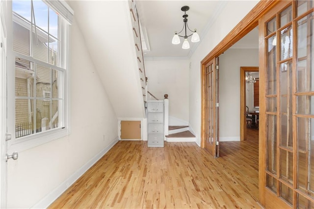 2031 General Taylor St, New Orleans, LA 70115 - foyer with crown molding, baseboards, a chandelier, and light wood-type flooring