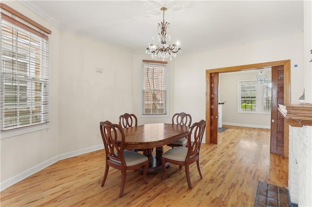 2031 General Taylor St, New Orleans, LA 70115 - dining room featuring a chandelier, light wood finished floors, baseboards, and ornamental molding